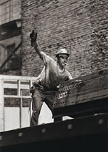 An ironworker signals co-workers