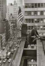 a steel worker atop a tall building