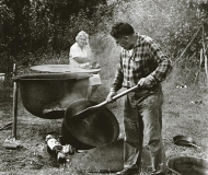 Ira Isham parches wild rice in a cast iron tub, Nett Lake, MN.